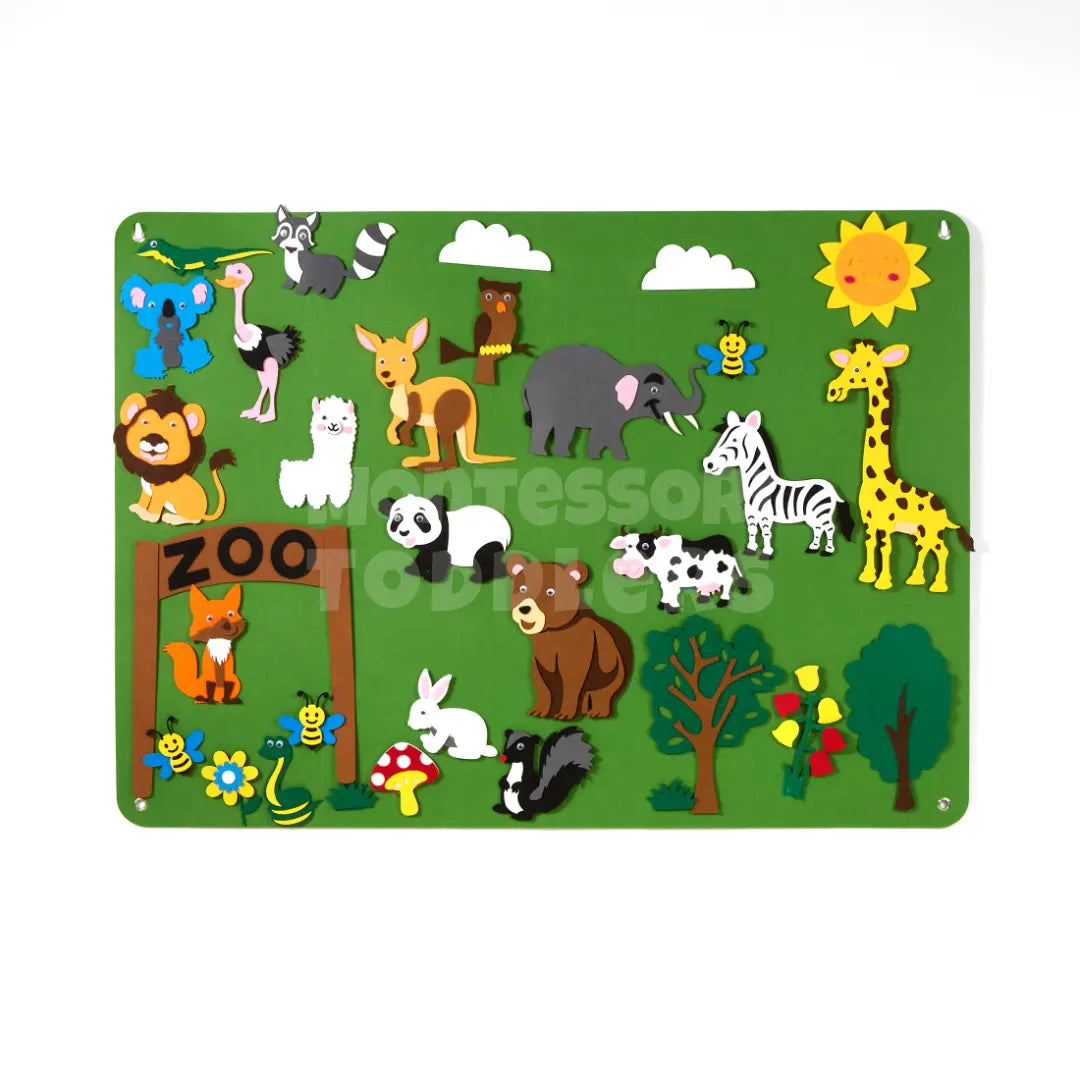 Zoo-themed felt board with animal pieces on a green scene