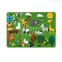 Zoo-themed felt board with animal pieces on a green scene