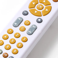 Toy remote control with large yellow and grey buttons