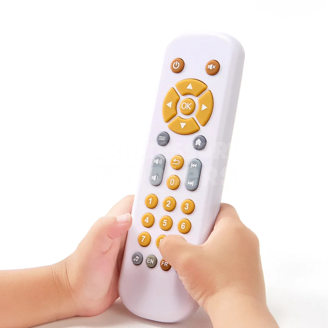Child's hand holding the toy learning remote control