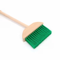 Wooden broom with green bristles