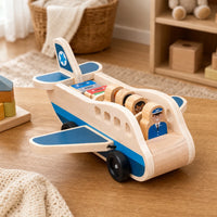Wooden Airplane Toy with Passengers & Luggage set out on a real table at home