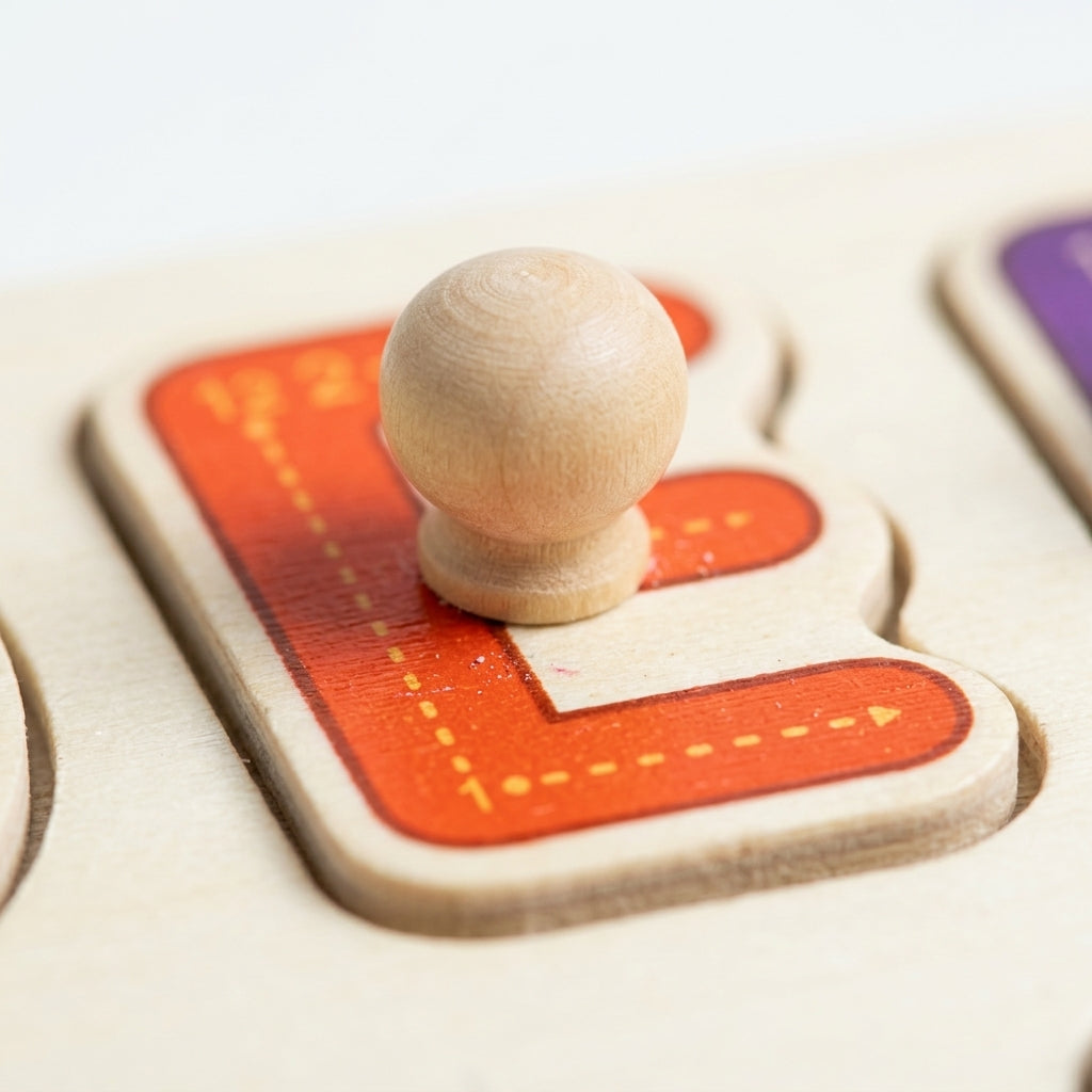 Close-up of a wooden alphabet puzzle letter with its knob