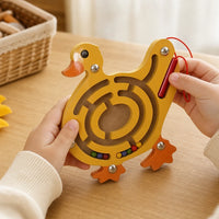 Close-up of a child's hands using the Wooden Animal Maze Duck