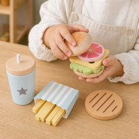 Close-up of a child's hands using the Wooden Burger Play Set Montessori Kitchen