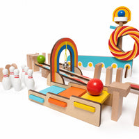 Wooden domino run set built with rainbow arch, ramp and skittles