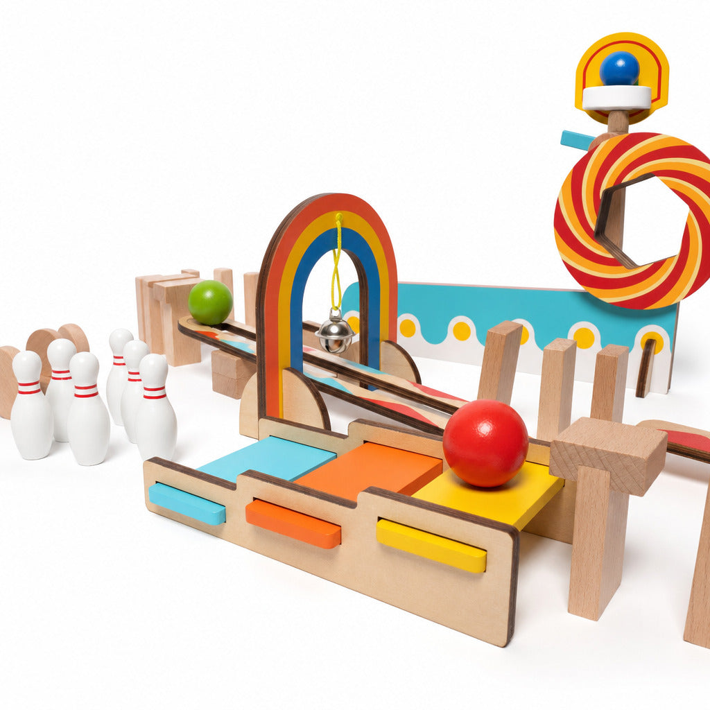 Wooden domino run set built with rainbow arch, ramp and skittles