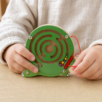Close-up of a child's hands using the Wooden Maze Toy Turtle