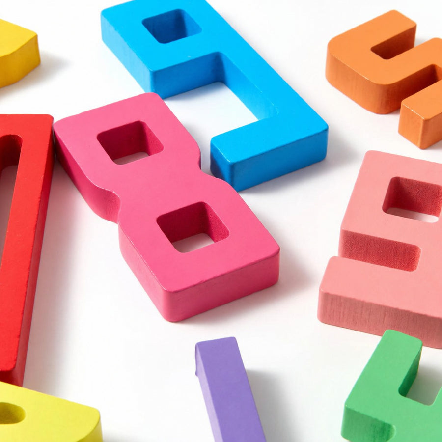 Scattered wooden numerals in bright colours