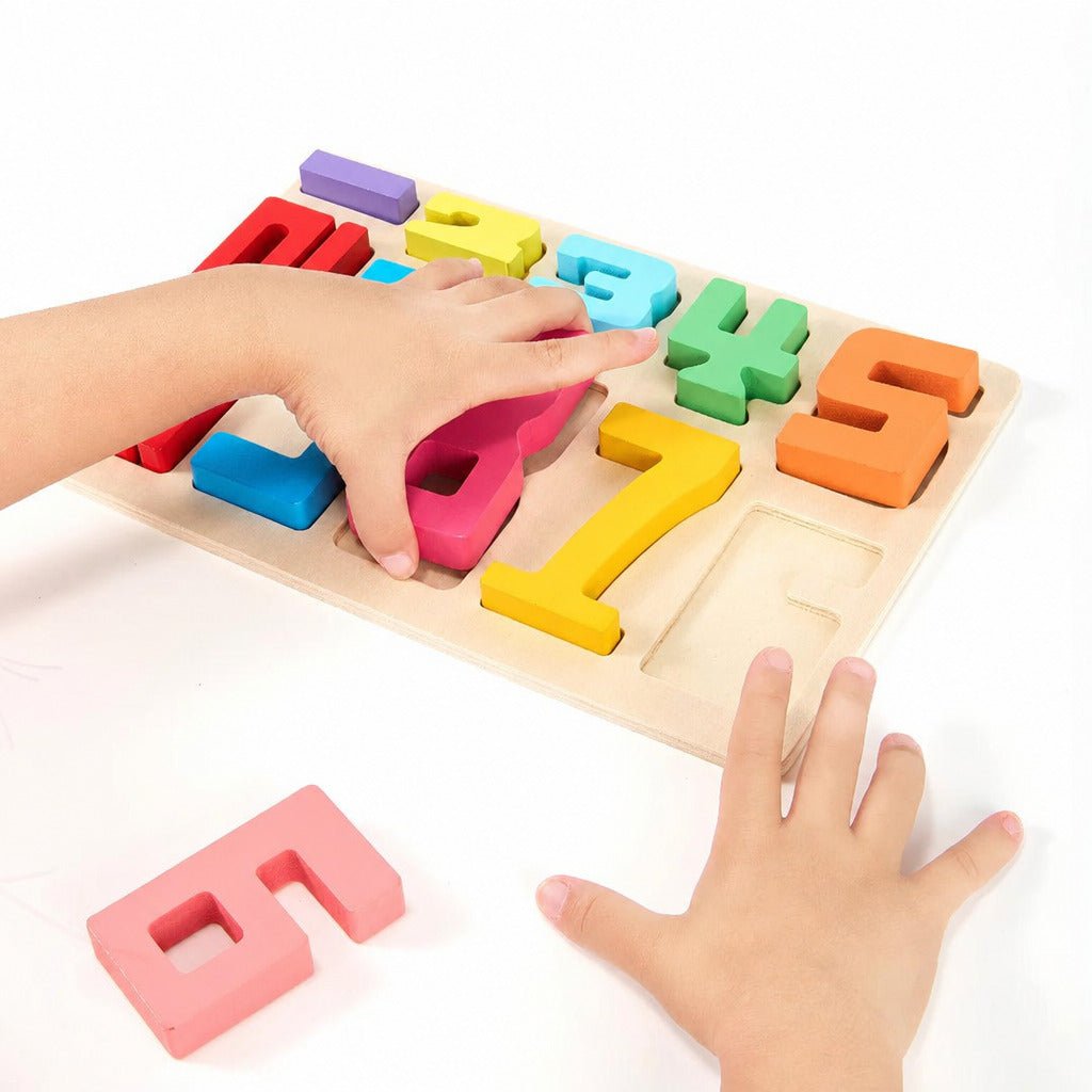 Child completing the wooden number board with loose numerals