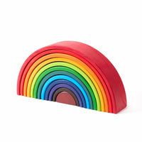 Wooden rainbow stacker nested into a compact half-circle