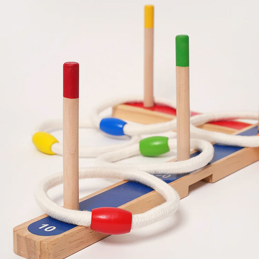 Wooden ring toss game with three pegs and rope rings