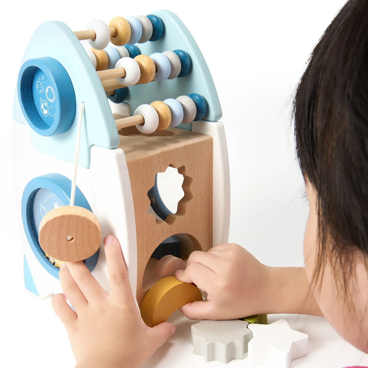 Child playing with the rocket activity centre's abacus and dials