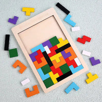 Wooden tetris puzzle partly assembled with loose pieces alongside