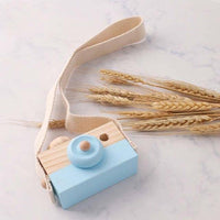 Wooden toy camera in blue with a cotton neck strap