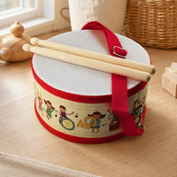 Wooden Toy Drum with Carry Strap set out on a real table at home